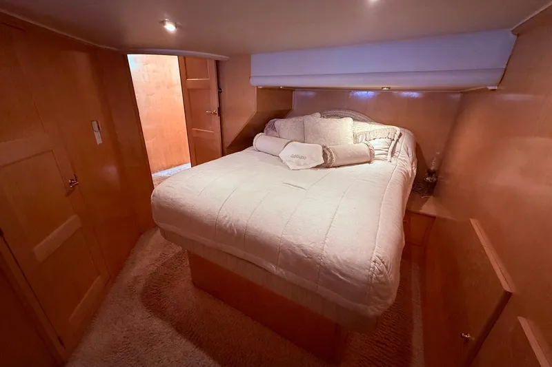 Slide: The Image of Luxurious bedroom interior of 2000 Navigator 53 yacht with cozy bedding and wooden finish. - 13