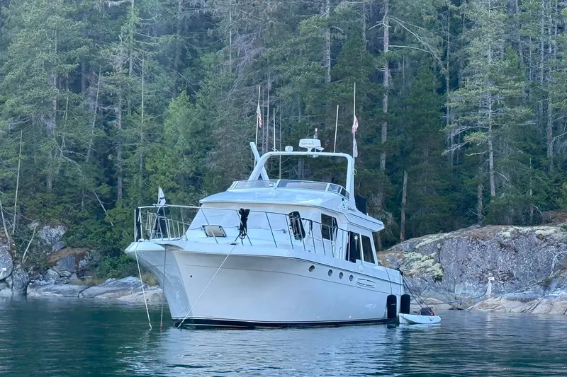 Slide: The Image of 2000 Navigator 53 yacht anchored in serene forested cove. - 2