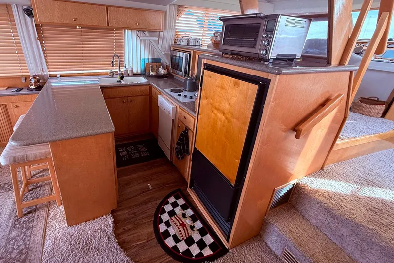 Slide: The Image of Cozy kitchen in 2000 Navigator 53 yacht with wood cabinetry and modern appliances. - 6