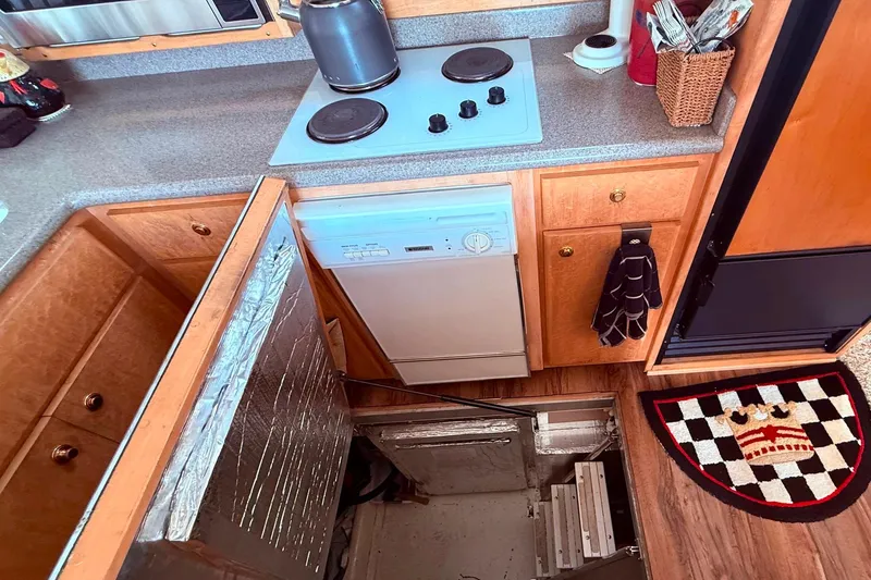 Slide: The Image of Compact kitchen in a 2000 Navigator 53 yacht with hidden storage access. - 7