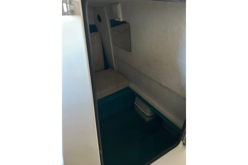 Slide: The Image of Interior cabin of 1991 Wellcraft 232 Eclipse boat, featuring seating and storage space. - 10