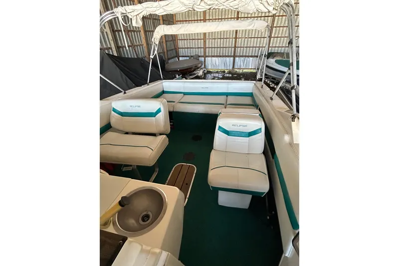 Slide: The Image of Interior of a 1991 Wellcraft 232 Eclipse boat with seating and canopy. - 11