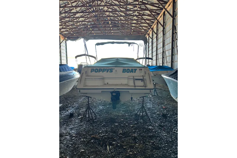 Slide: The Image of 1991 Wellcraft 232 Eclipse boat named "Poppy's Boat" stored in a covered facility. - 13