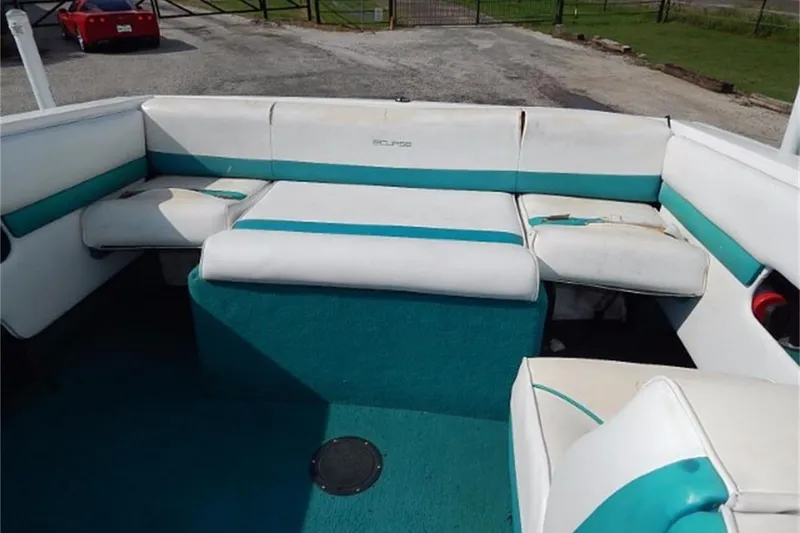 Slide: The Image of 1991 Wellcraft Eclipse 232 boat interior with white and teal seating. - 3