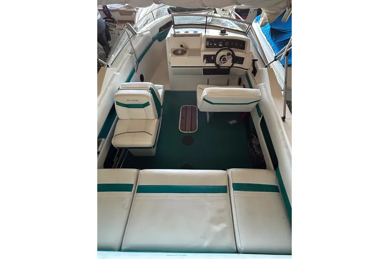 Slide: The Image of 1991 Wellcraft 232 Eclipse boat interior with white and teal seating, steering wheel, and dashboard. - 6