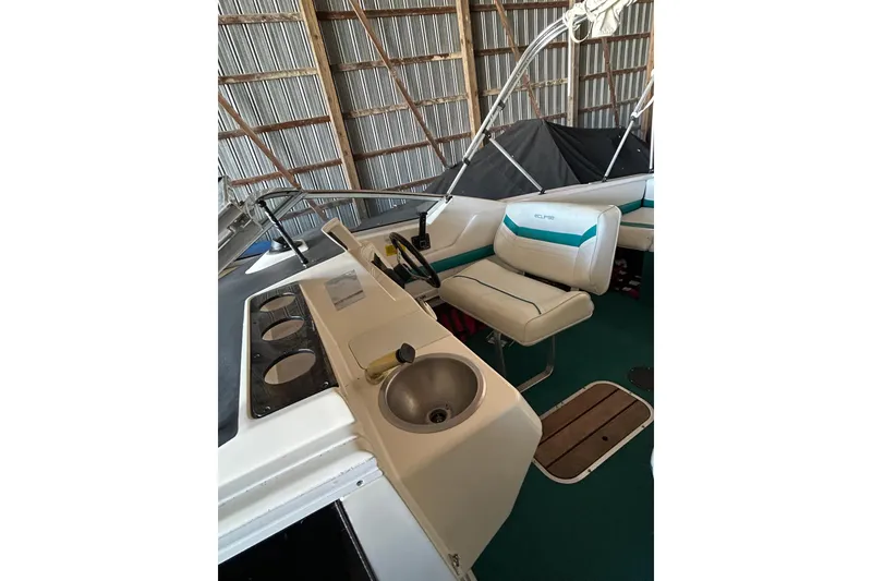 Slide: The Image of 1991 Wellcraft 232 Eclipse boat interior with seating and sink in storage. - 7