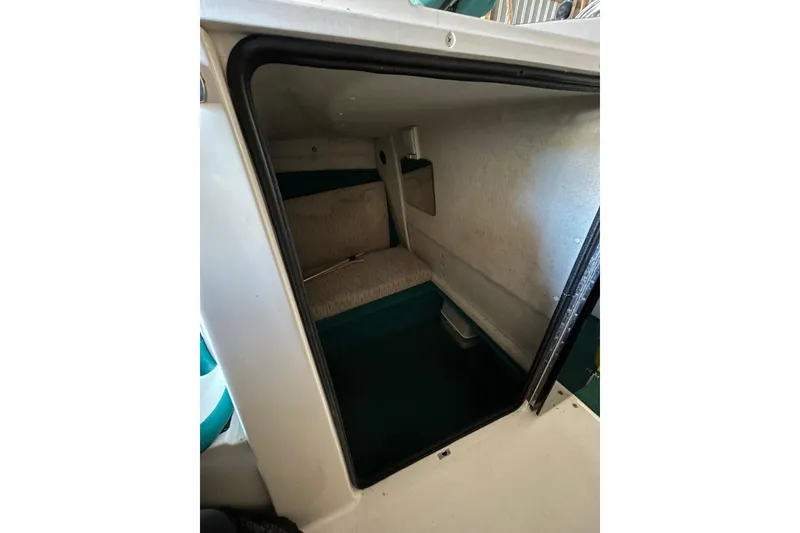 Slide: The Image of Interior cabin of 1991 Wellcraft 232 Eclipse boat, featuring compact sleeping area. - 8