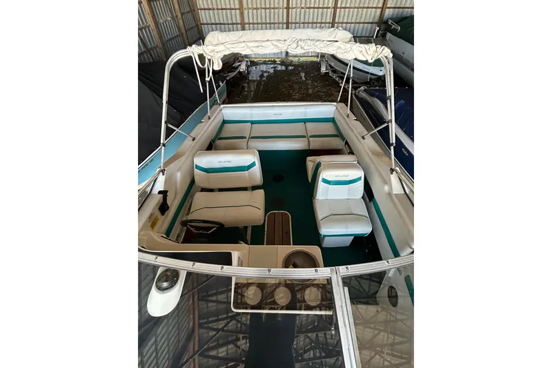 Slide: The Image of 1991 Wellcraft 232 Eclipse boat interior with seating and canopy in storage. - 9