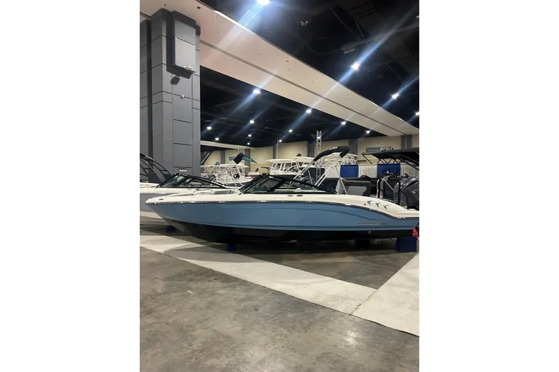The Image of 2026 Chaparral 21 SSi OB boat displayed indoors at a boat show. - 0