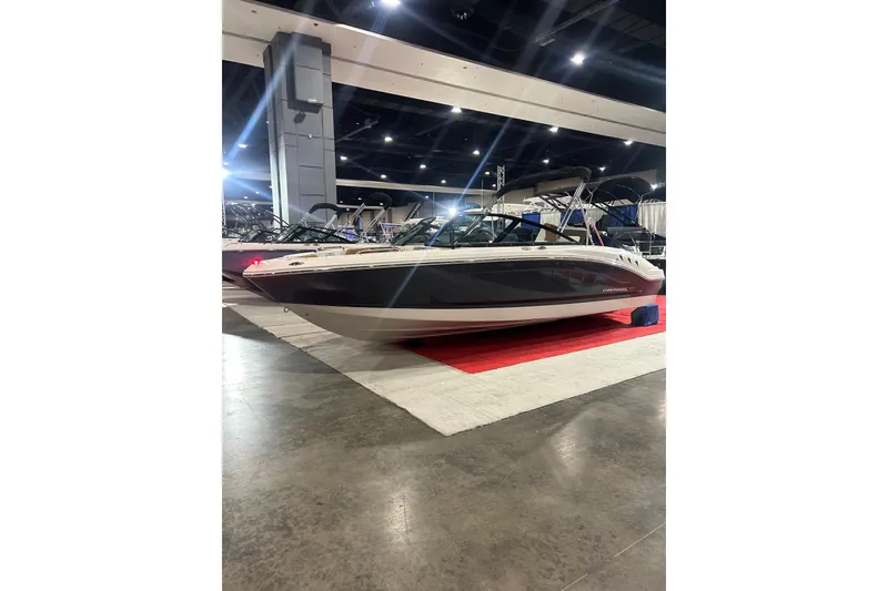 Slide: The Image of 2026 Chaparral 21 SSi boat displayed indoors on red carpet. - 2