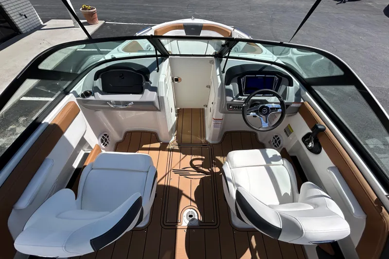 Slide: The Image of 2026 Chaparral 21 SSi boat interior with modern dashboard and comfortable seating. - 8