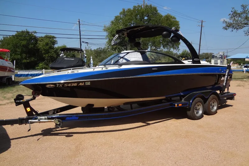 The Image of 2007 Malibu Wakesetter 23 LSV boat on trailer, parked outdoors on a sunny day. - 0