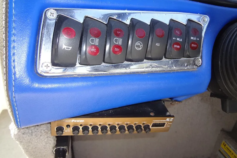 Slide: The Image of Control panel of a 2007 Malibu Wakesetter 23 LSV boat with various switches. - 13
