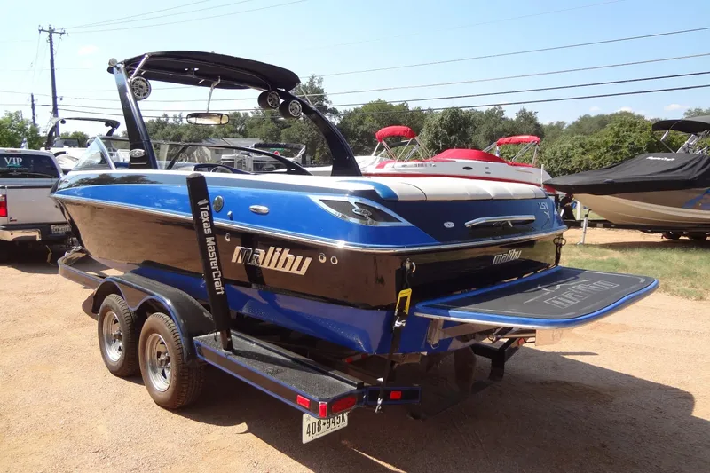 Slide: The Image of 2007 Malibu Wakesetter 23 LSV boat on trailer, blue and black design. - 2