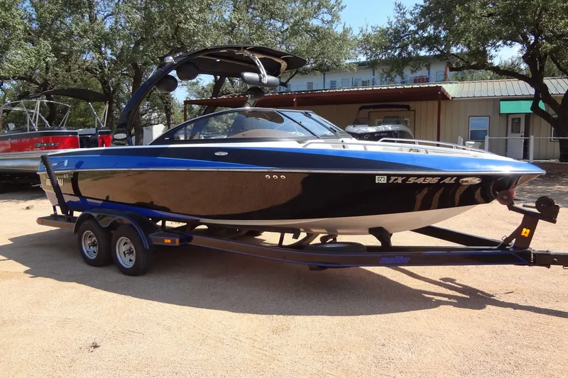 Slide: The Image of 2007 Malibu Wakesetter 23 LSV boat on trailer, parked outdoors. - 6