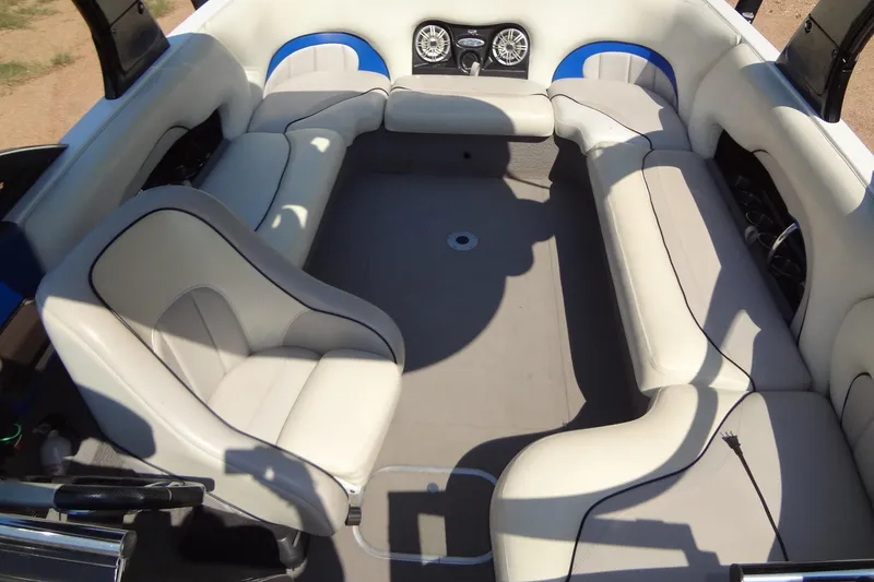 Slide: The Image of 2007 Malibu Wakesetter 23 LSV interior with white seating and built-in speakers. - 9