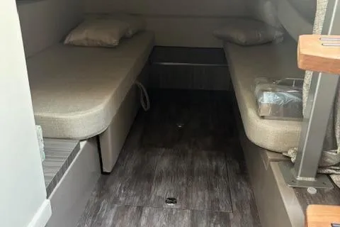 Slide: The Image of 2024 Sea Ray Sundancer 320 cabin interior with twin beds and modern flooring. - 13