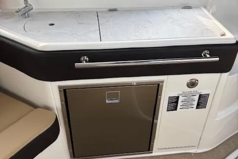 Slide: The Image of 2024 Sea Ray Sundancer 320 boat interior with kitchenette and mini fridge. - 15