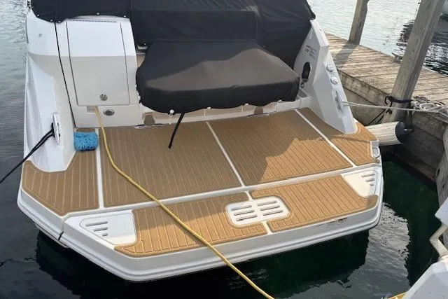 Slide: The Image of 2024 Sea Ray Sundancer 320 swim platform with teak decking at a dock. - 6