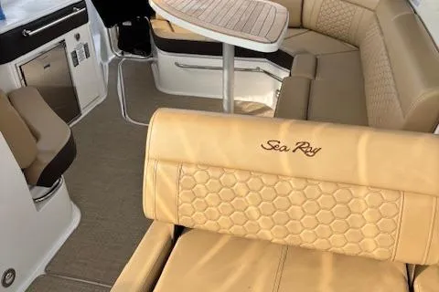 Slide: The Image of 2024 Sea Ray Sundancer 320 interior with beige seating and table. - 8