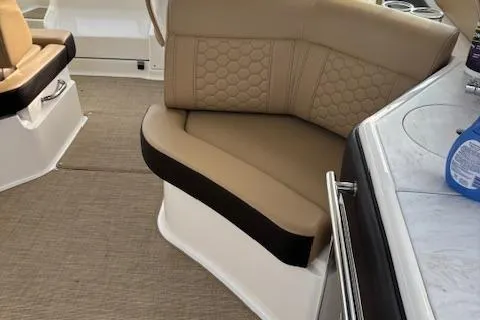Slide: The Image of 2024 Sea Ray Sundancer 320 interior with beige seating and modern design. - 9