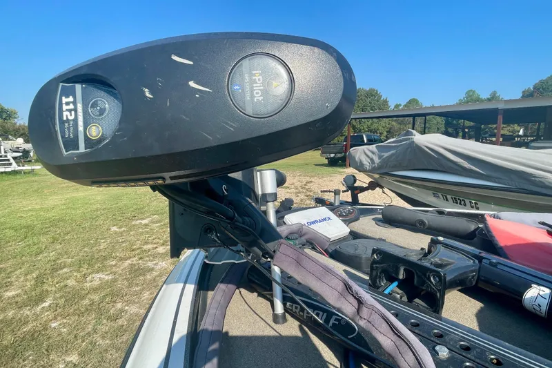 Slide: The Image of 2012 Triton 21 XS Elite boat with i-Pilot trolling motor in a grassy area. - 2