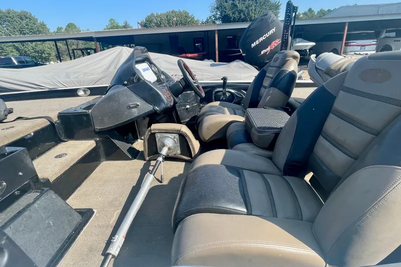 Slide: The Image of 2012 Triton 21 XS Elite boat interior with seating and steering console. - 4