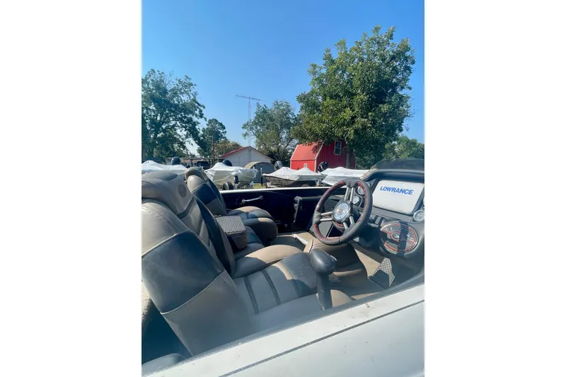 Slide: The Image of 2012 Triton 21 XS Elite boat interior with steering wheel and Lowrance display. - 5