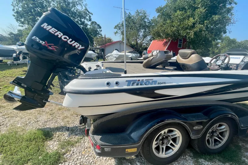 Slide: The Image of 2012 Triton 21 XS Elite boat with Mercury Pro XS engine, parked outdoors. - 6