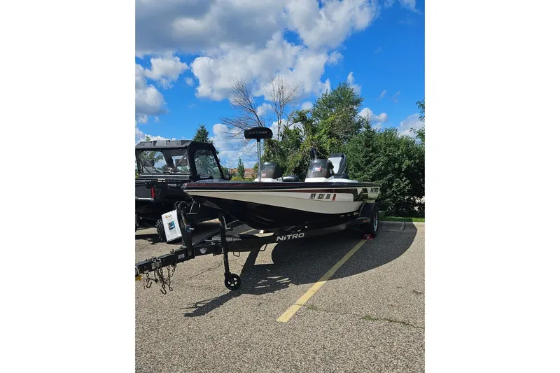 The Image of 1997 Nitro 884 Savage boat on trailer under blue sky. - 1