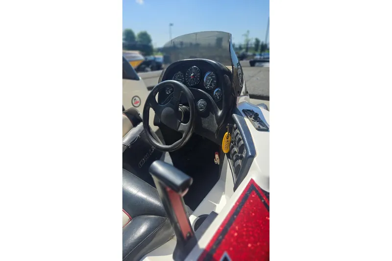 Slide: The Image of 1997 Nitro 884 Savage boat dashboard with steering wheel and gauges. - 2