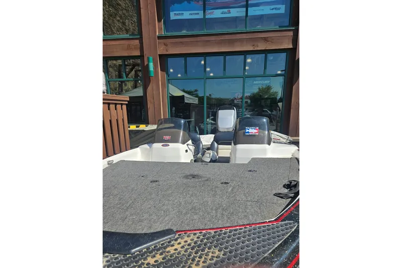 Slide: The Image of 1997 Nitro 884 Savage boat parked outside a building with large windows. - 4