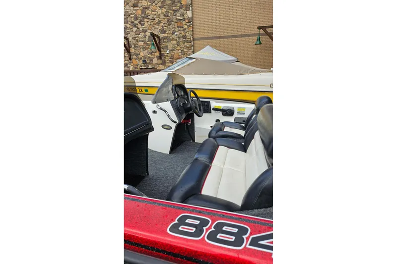 Slide: The Image of 1997 Nitro 884 Savage boat interior with black and white seating, steering wheel, and dashboard. - 5