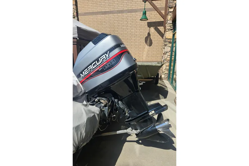 Slide: The Image of Outboard motor on a 1997 Nitro 884 Savage boat, parked outdoors. - 6
