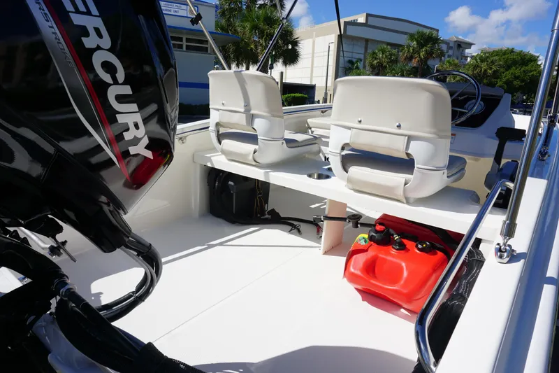 Slide: The Image of 2026 Boston Whaler 130 Super Sport interior with Mercury engine and seating. - 11