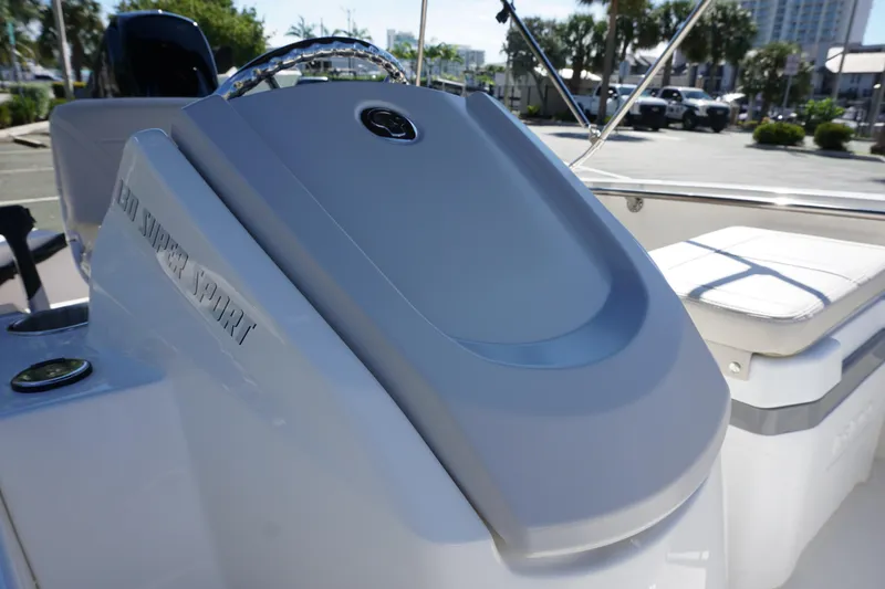 Slide: The Image of 2026 Boston Whaler 130 Super Sport boat console and seating detail. - 15