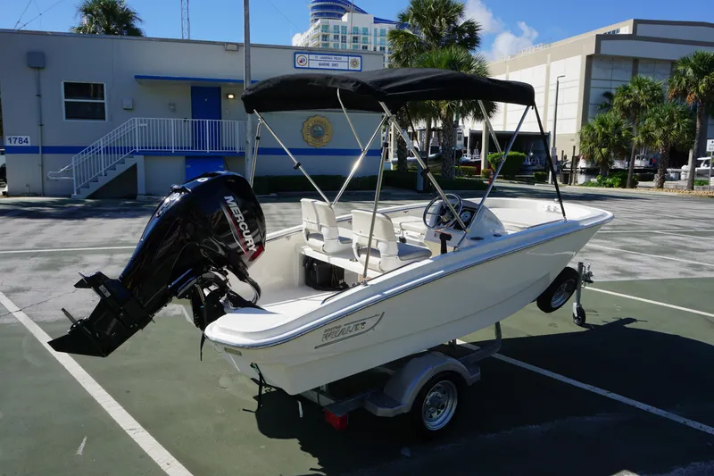Slide: The Image of 2026 Boston Whaler 130 Super Sport boat with Mercury engine on trailer. - 4