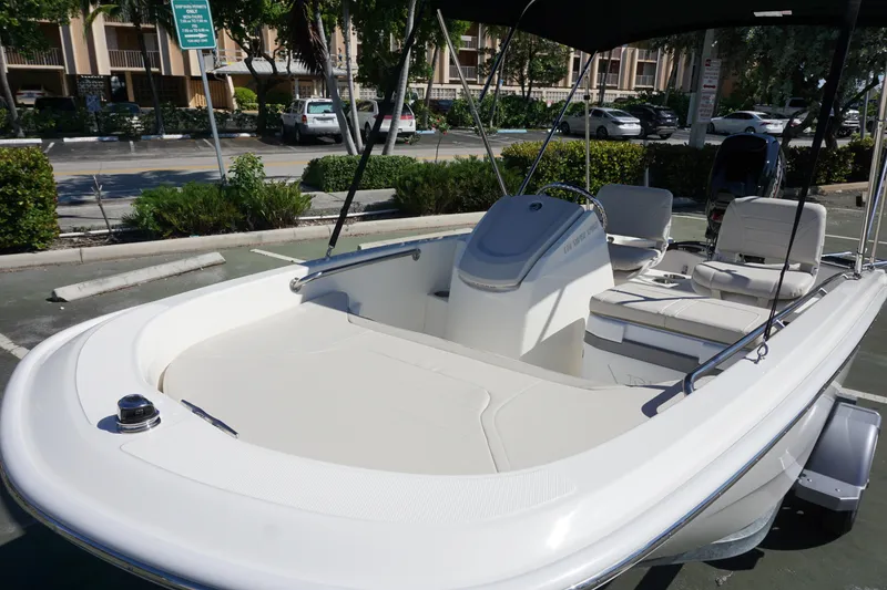 Slide: The Image of 2026 Boston Whaler 130 Super Sport boat parked in a sunny outdoor setting. - 8