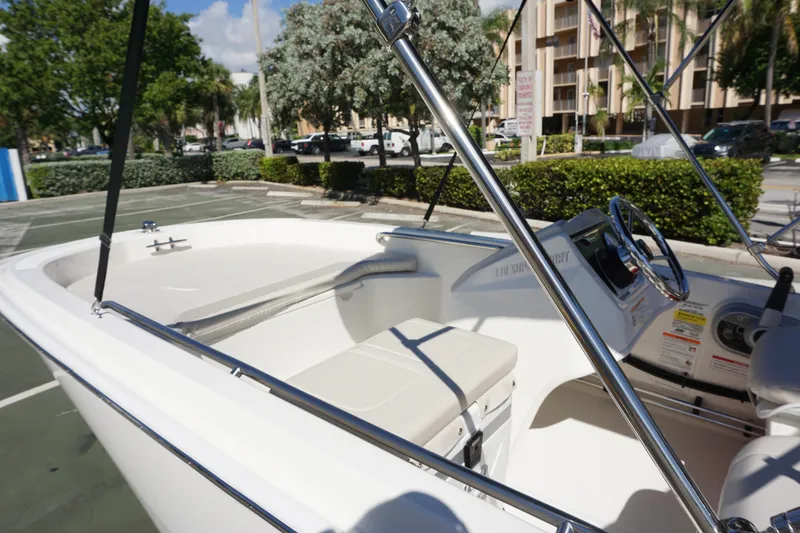 Slide: The Image of 2026 Boston Whaler 130 Super Sport boat interior with steering wheel and seating. - 9