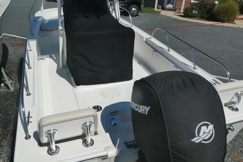 Slide: The Image of 2022 Boston Whaler 190 Montauk boat with Mercury engine, parked outdoors. - 3