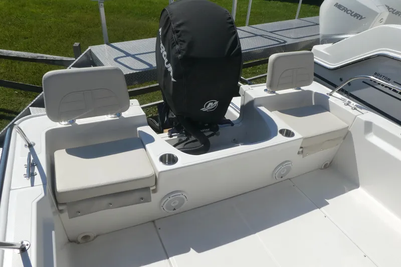 Slide: The Image of 2022 Boston Whaler 190 Montauk boat interior with seating and Mercury engine cover. - 5