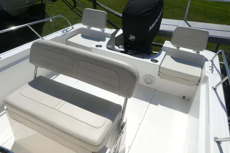 Slide: The Image of 2022 Boston Whaler 190 Montauk boat interior with seating and motor. - 6