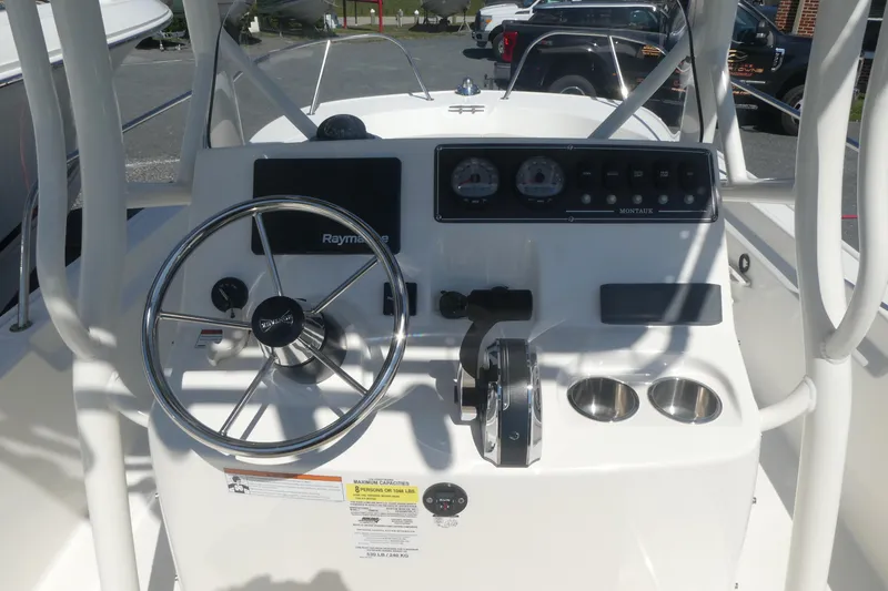 Slide: The Image of 2022 Boston Whaler 190 Montauk boat dashboard with steering wheel and controls. - 8