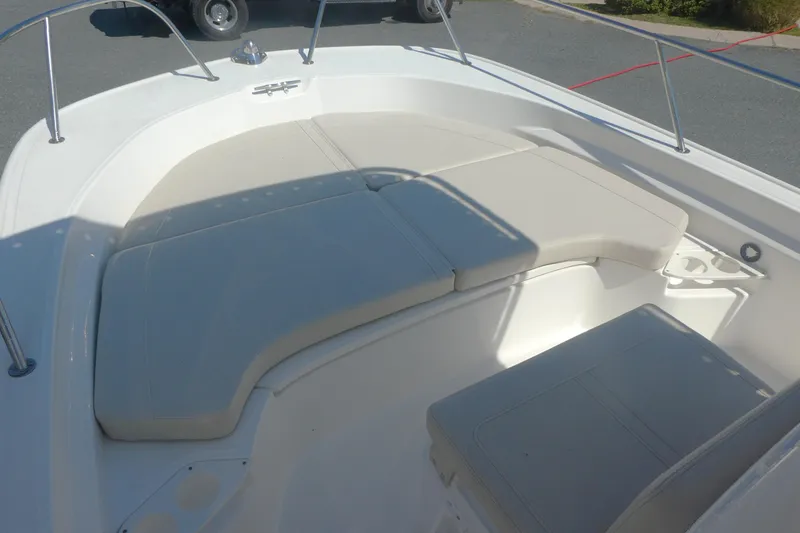 Slide: The Image of 2022 Boston Whaler 190 Montauk boat interior with cushioned seating area. - 9