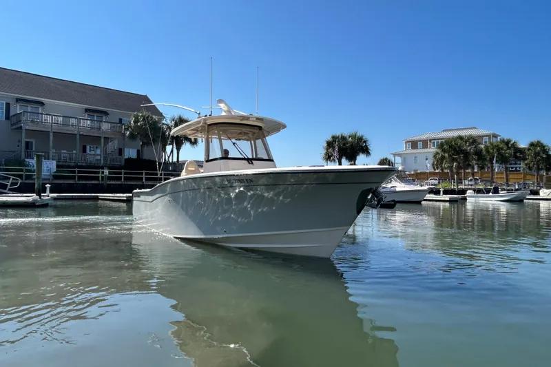 Slide: The Image of 2020 Grady-White Canyon 306 boat docked in a sunny marina setting. - 1