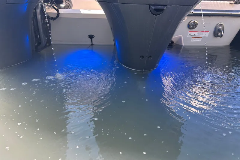 Slide: The Image of 2020 Grady-White Canyon 306 boat engines with water and blue lighting. - 10