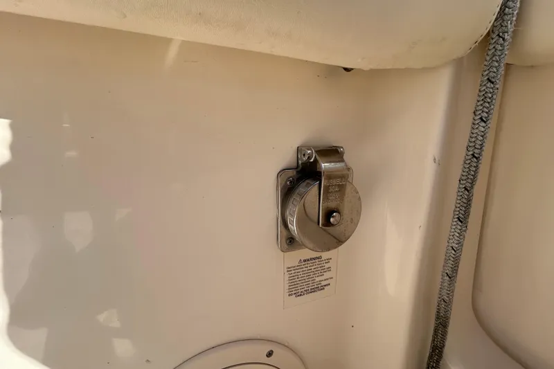 Slide: The Image of Grady-White Canyon 306 boat detail, 2020 model, featuring a metal fixture and warning label. - 15