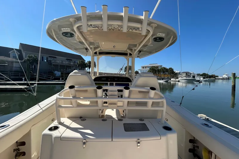 Slide: The Image of 2020 Grady-White Canyon 306 boat interior at marina, clear sky, calm water. - 18