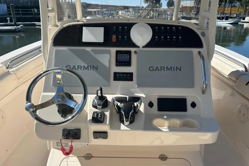Slide: The Image of 2020 Grady-White Canyon 306 boat dashboard with Garmin navigation system and steering wheel. - 23