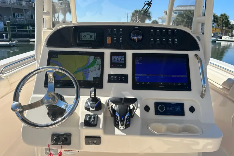 Slide: The Image of 2020 Grady-White Canyon 306 boat dashboard with navigation and control systems. - 24